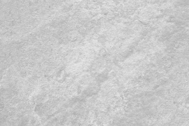 Light grey rough stone wall for abstract background and texture for interior or exterior design. Beautiful patterns, space for work, banner, wallpaper close up.
