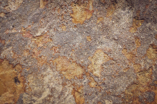 istock Brown grey rough stone wall with surface black orange rusted for abstract background and texture, interior or exterior design. Beautiful patterns, space for work, banner, close up. 2199661201