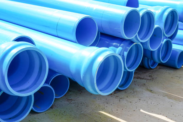 istock Stack of large blue water pipes, PVC nylon water pipes unpacked used on the construction site for installation, water supply repair or plumbing drain infrastructure earthworks. 2199664210