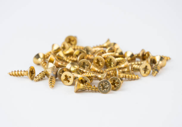 istock A collection of gold screws placed closely together on a plain surface 2199669099