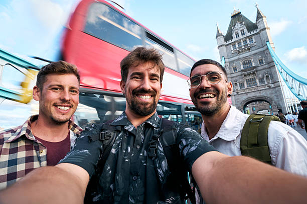 istock Tourists taking selfie with red bus and tower bridge in london 2199675486