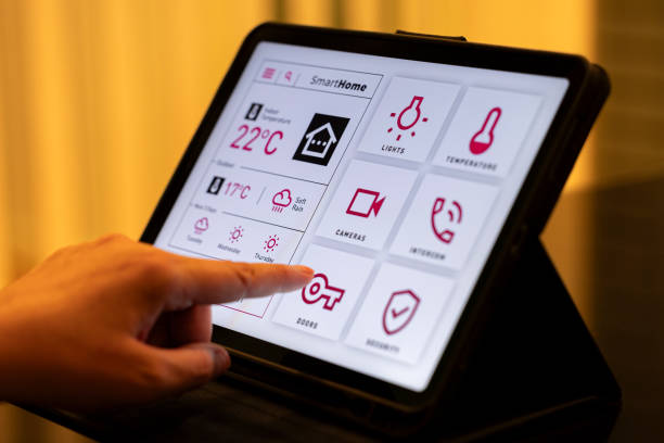 istock Smart Home Control Tablet with Interactive UI in Cozy Living Room at Night 2199676786