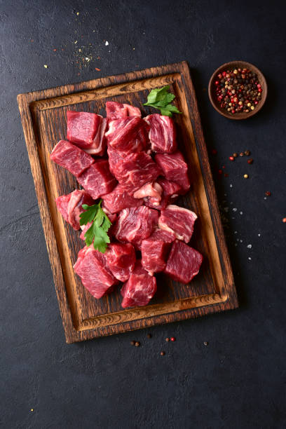 istock Cubes of raw organic meat ( beef or lamb ) . Top view with copy space. 2199676949