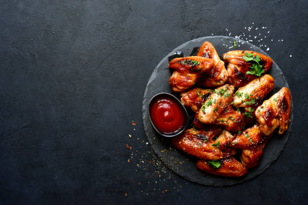 istock Grilled spicy chicken wings with ketchup  . Top view with copy space. 2199677186