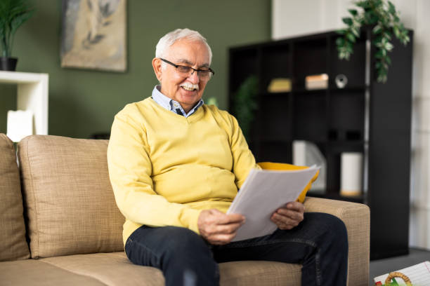 istock Senior man enjoying at home and reading some documents 2199679397