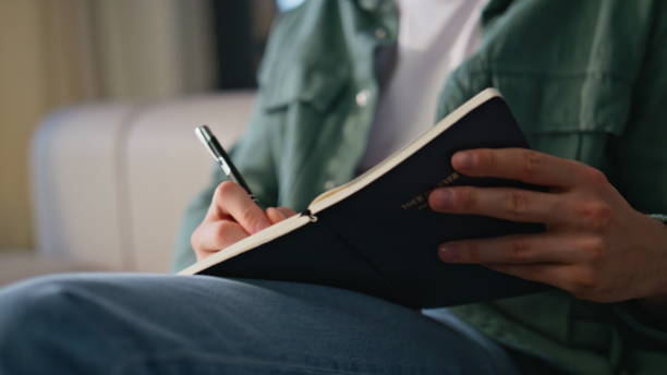 istock Man hand making notes in copybook listening online webinar studying on laptop 2199679454