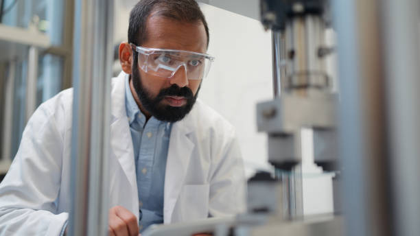 istock Young ethnic male scientist working in laboratory 2199680536