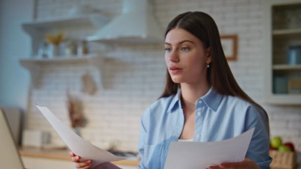 istock Joyful employee checking papers in home office closeup. Manager looking laptop 2199680811