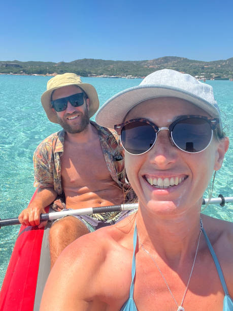 istock Couple Kayaking on Crystal Clear Water in Sunny Paradise 2199685633