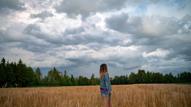 istock Woman gazing into the storm clouds 2199685988
