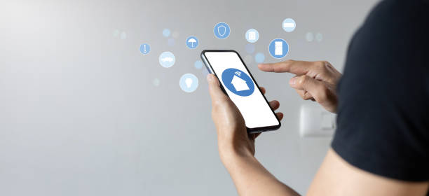 istock close up man hand holdings smartphone and open application technology for using home automation function with wifi 7  to looking inside or outside home and property for  ai innovation future concept 2199686776