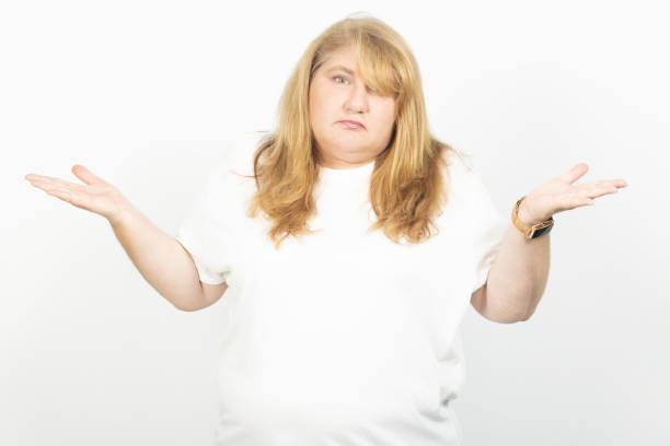 istock Confused Plus Size Woman Shrugging with Raised Hands 2199696325