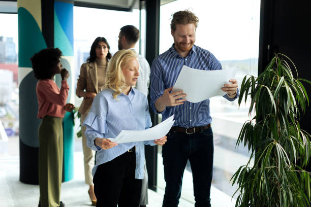 istock Young business team working together and looking at paperwork 2199699739