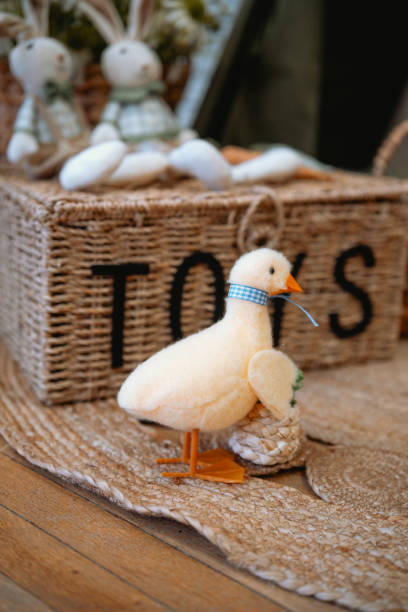 istock Decorative yellow duck figurine beside handmade toys in a cozy interior setting 2199699993