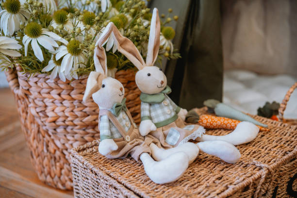 istock Decorative stuffed bunnies with a floral arrangement in a cozy setting 2199700005