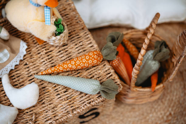 istock Colorful fabric carrots in a woven basket surrounded by decorative items 2199700024