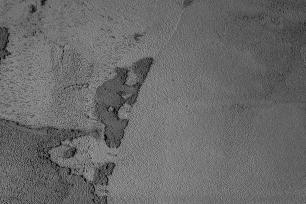 A close-up view of a textured gray surface with varying tones and patterns.