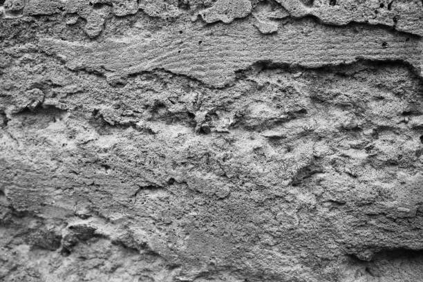 istock Texture of weathered concrete wall with intricate patterns and shadows 2199700139