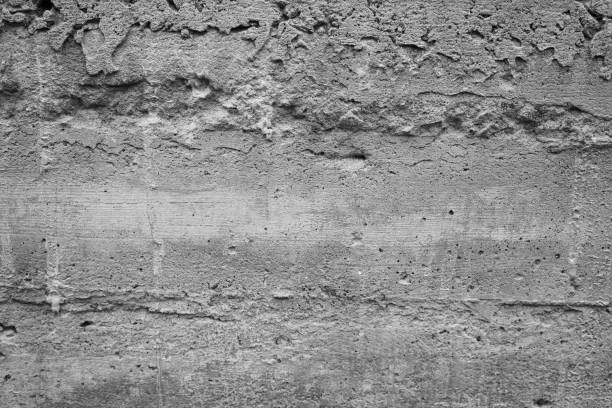 istock Textured gray concrete wall with visible imperfections and patterns 2199700141