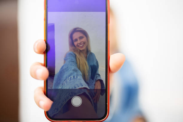 istock Mobile phone screen with woman selfie 2199700384