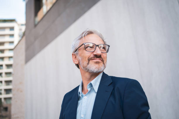 istock Confident senior businessman looking inspired in urban setting 2199700732