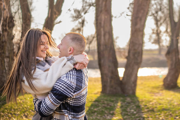 Happy couple enjoys their love while spinning in a circle on a mountain. Love, beauty, nature.