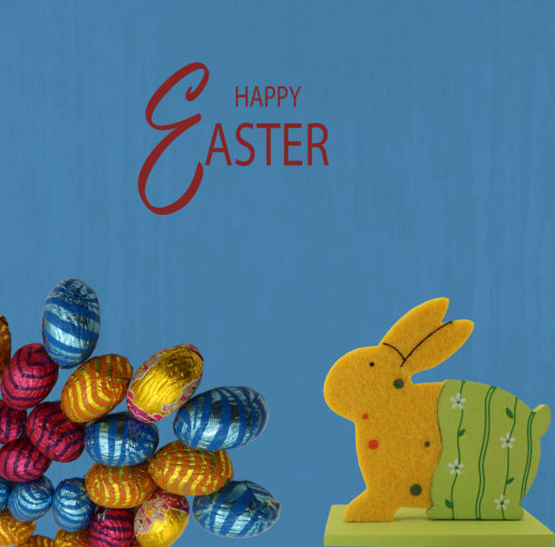 A vibrant Easter greeting card with a playful wooden bunny next to a pile of multicolored eggs. The deep blue background enhances the contrast, making the yellow rabbit and bright eggs pop.