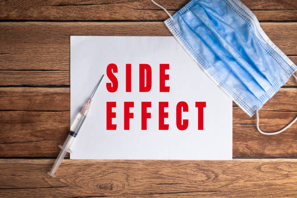 istock side effect words text on white paper with syringe and mask on wooden background 2199716977