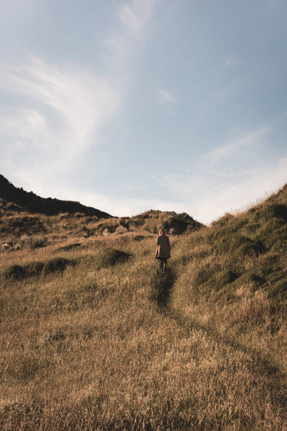 Girl walking on long grass