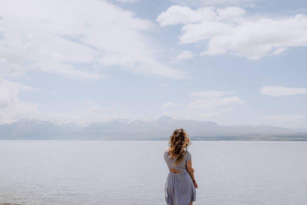 istock Girl watching the lake 2199721653