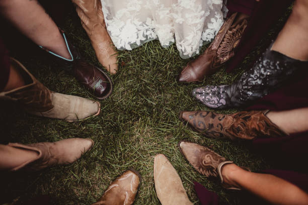 istock Bride and bridesmaids in cowboy boots with focus on feet 2199726248