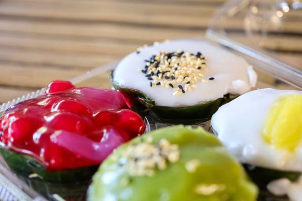 a tray of khanom tako (coconut cream and rice flour puddings) for sale at a floating market in bangkok - khlong toei stock-fotos und bilder