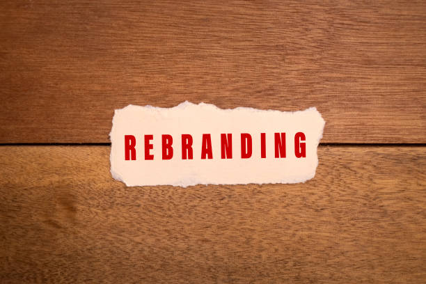 istock rebranding word text on torn paper on wooden background 2199730773