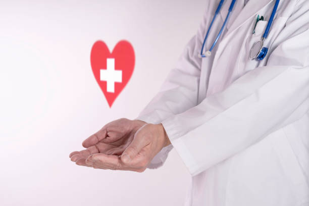 istock Doctor and a white cross inside a red heart 2199732676