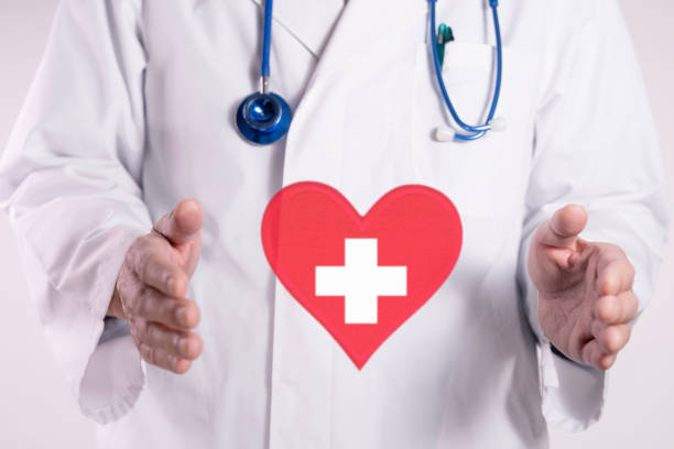 istock Doctor and a white cross inside a red heart 2199732680