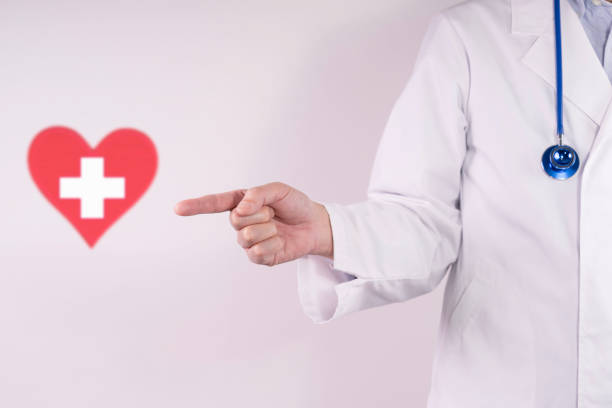 istock Doctor and a white cross inside a red heart 2199732682