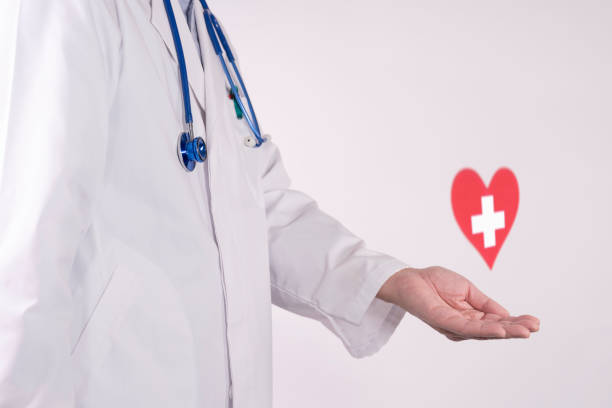 istock Doctor and a white cross inside a red heart 2199732687