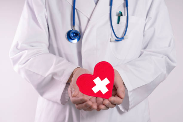 istock Doctor and a white cross inside a red heart 2199732691