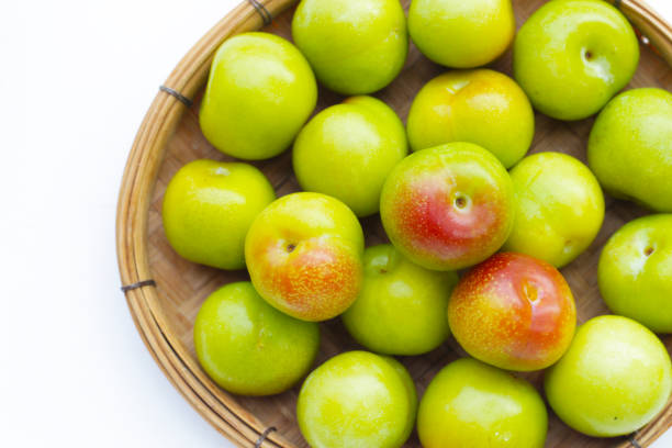 Fresh green plum on white background