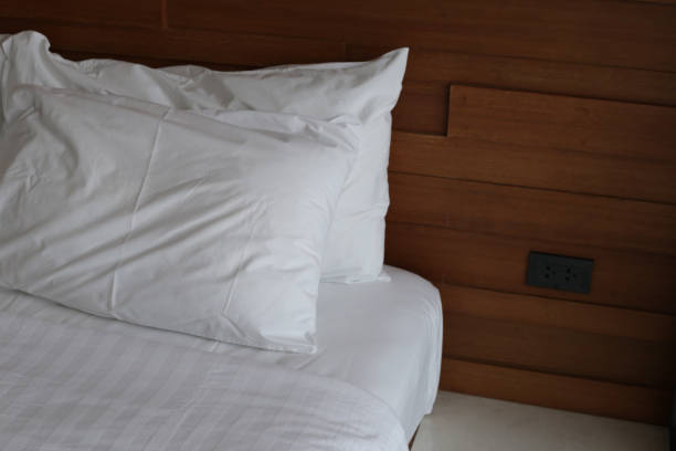 istock Bed with pillows in bedroom hotel 2199734826