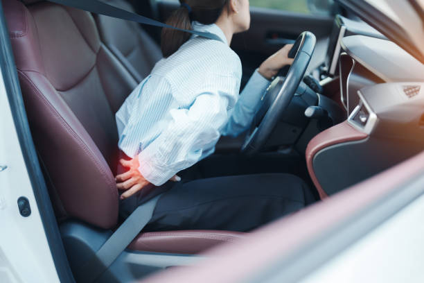 istock woman with her back sprain while driving car long time, back body ache due to Piriformis Syndrome, Low Back Pain and Spinal Compression. Ergonomic and medical concept 2199735143
