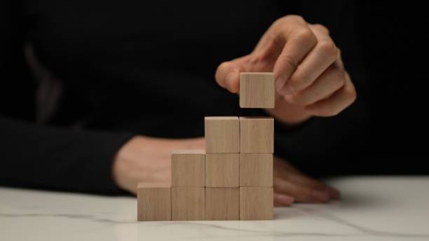 istock Building blocks of creativity stacking wooden cubes home studio minimalistic environment close-up viewpoint concept of growth and development 2199737501