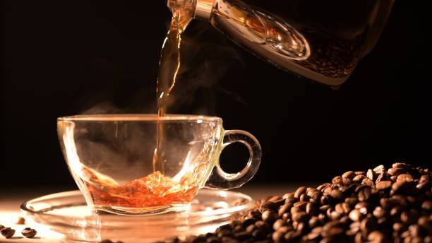 istock Pouring freshly brewed coffee into a clear glass cup coffee shop beverage soft lighting close-up cozy atmosphere 2199737653