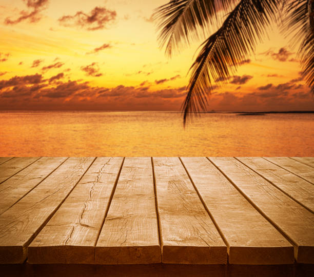 istock Empty wooden table top with tropical ocean sunset background 2199738244