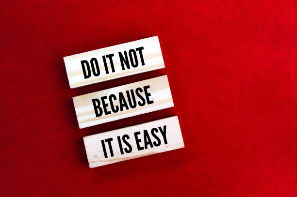 istock sticks arranged with the word do it not because it is easy 2199744992