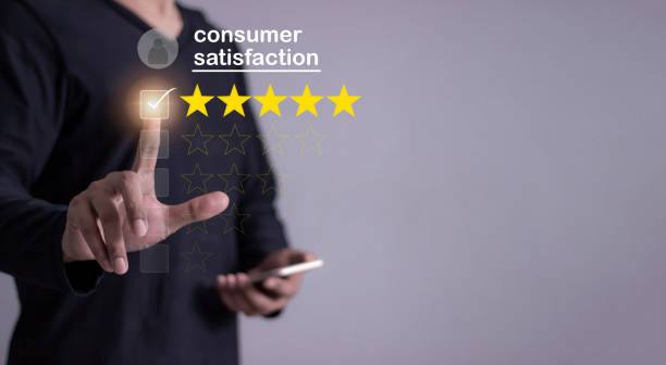 istock Consumer Satisfaction, Young Man with smartphone mobile hand touching five star to review and give 5 stars with very good results in service, Good review 5 star rating choice feedback 2199745015