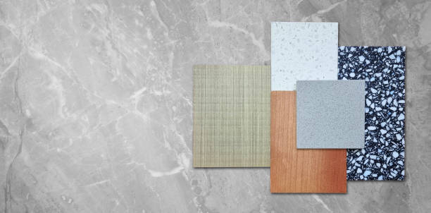 istock interior material samples mood and tone board contains ash and oak wooden veneer, artificial stone, marble terrazzo stone placed on grey marble background. 2199750367