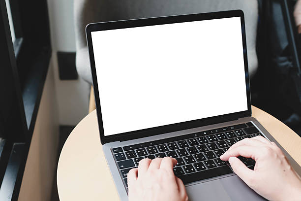 istock A white blank screen for hand typing text,using laptop contact business searching information in workplace on desk at cafe. 2199753222