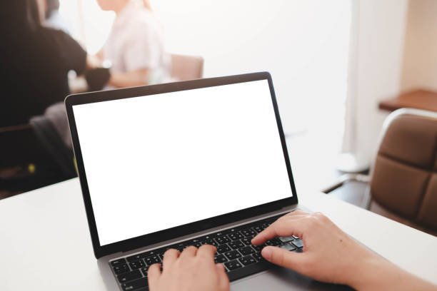 istock A white blank screen for hand typing text,using laptop contact business searching information in workplace on desk at cafe. 2199753227