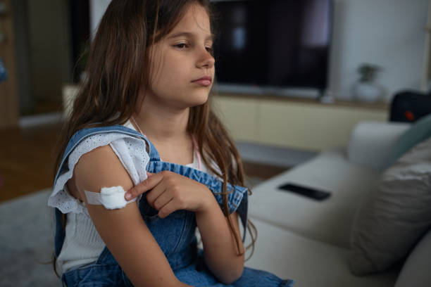 istock Child with bandage on arm after vaccine 2199753792